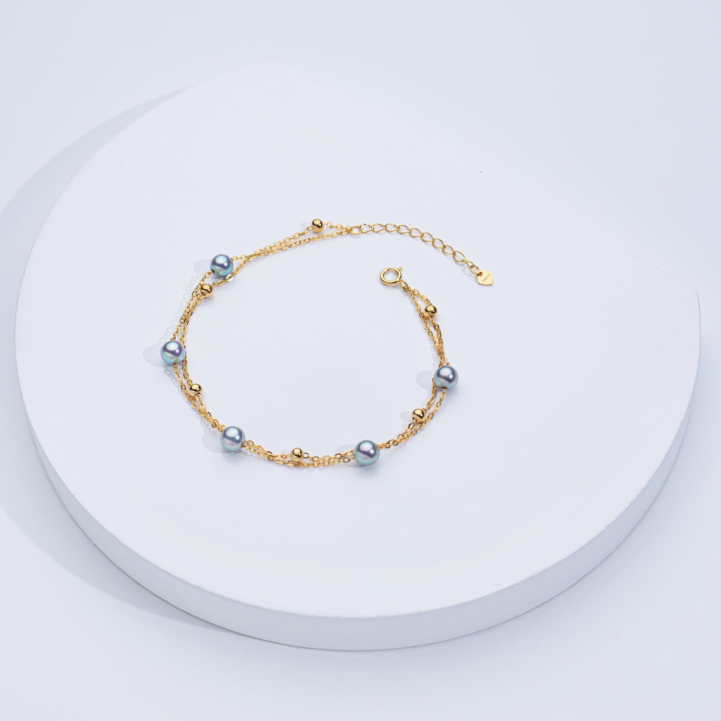 Two Akoya sea pearl double layer bracelets, one with silver color and the other with gold color, displayed on a white surface.